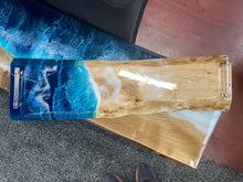 Load image into Gallery viewer, Live Edge Maple, long and slightly narrow, rich warm blonds and golds, Live Edge Walnut, rich browns and warm golds, food safe epoxy covering 100% of wood in a wave pattern white, clear, light and dark blues with clear tube handles.