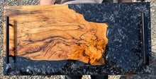 Load image into Gallery viewer, Live Edge Spalted Walnut, rich warm browns and golds, 100% of wood covered with food safe epoxy, metallic black with silver swirls pattern along board of board and side with black tube handles.
