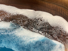Load image into Gallery viewer, Live Edge Walnut, rich browns and golds, food safe epoxy covering 90% of wood in a wave pattern white, clear, teal blue with boat cleat handles.
